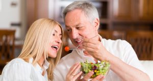 man and woman share a salad