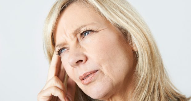 Woman concentrating with hand on head