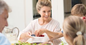 Grandmother eating with family