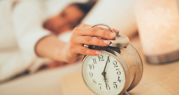 Hand turning off alarm clock