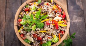 fresh quinoa salad in wooden bowl