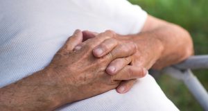 close up of man's hands resting on his stomach