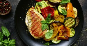 Plate of grilled chicken and roasted vegetables