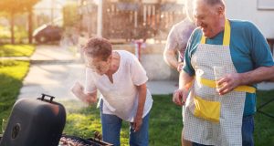 Family having fun grilling outside together