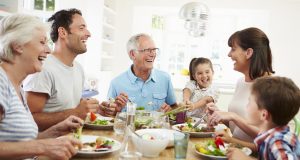 Smiling family eating together at the table