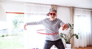 Senior man having fun with hula hoop