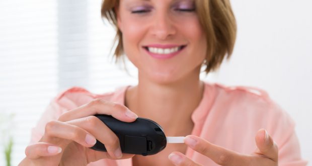 Woman checking her blood sugar