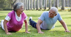 Active older couple exercising in the park