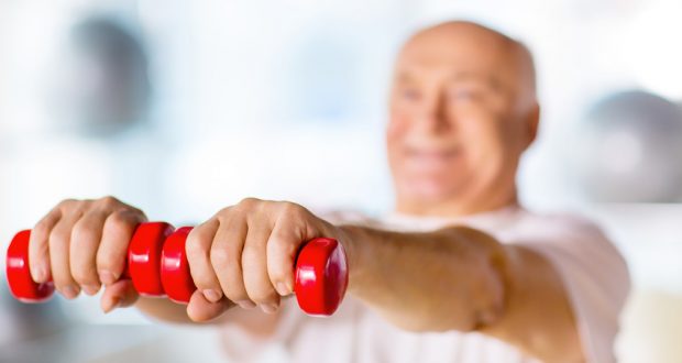 Older man lifting small weights