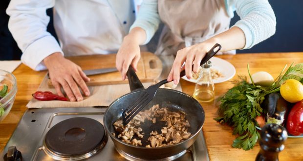 Couple cooking meal at home