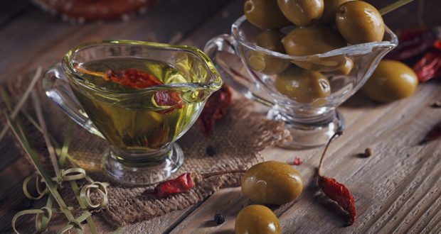 Olive oil and olives in glass bowls