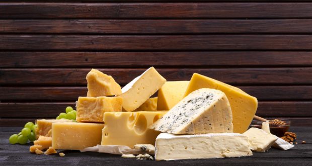 Selection of cheeses on wooden board