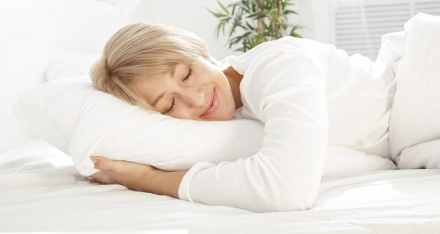 Smiling woman sleeping in bed