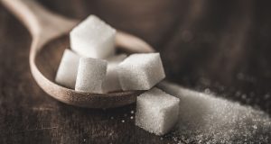 Sugar cubes in wooden spoon