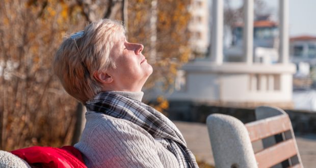 Woman outside, sun shining on her face